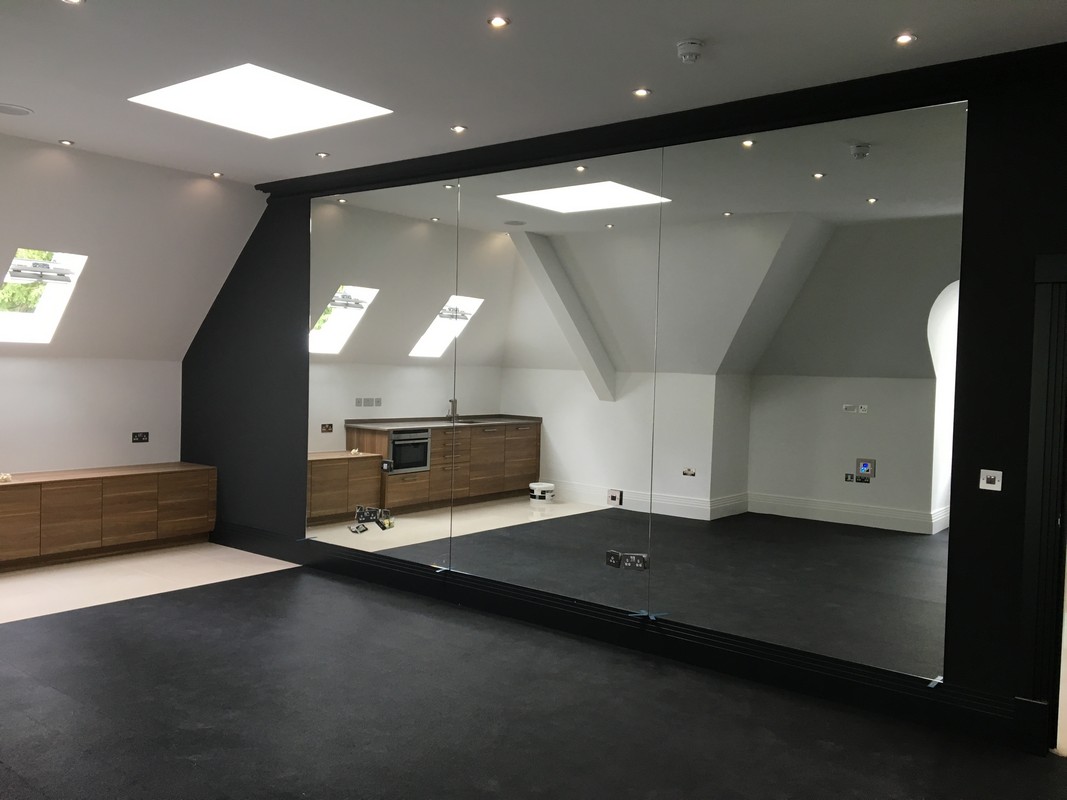 Frameless glass wall dividing loft conversion in Hammersmith