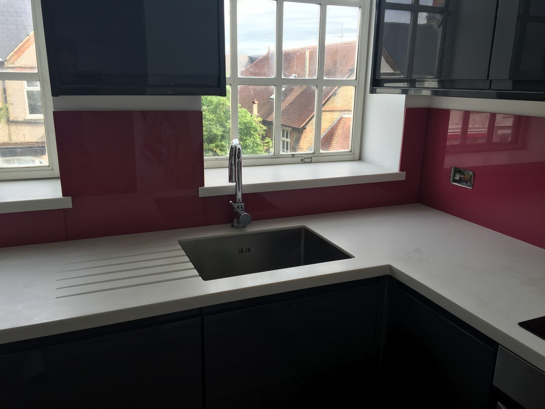 Deep plum coloured glass splashback in modern Hammersmith kitchen
